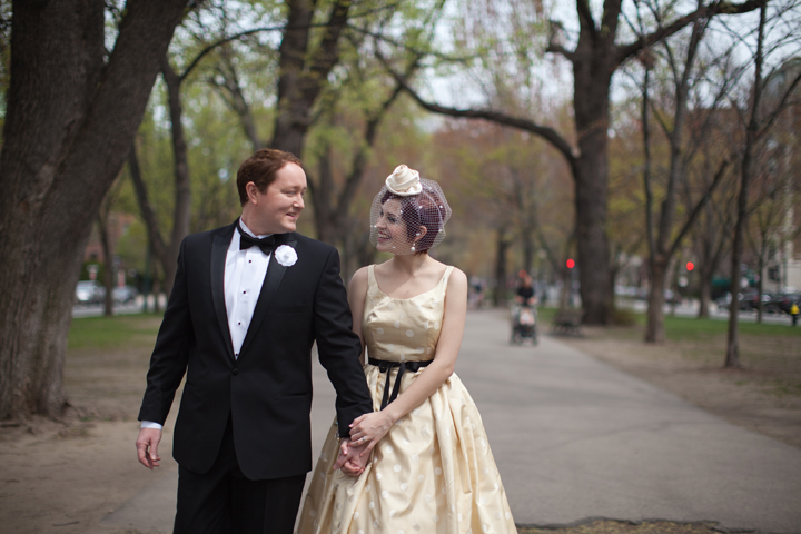 Bride and groom walking hand in hand on Comm Ave in Boston MA